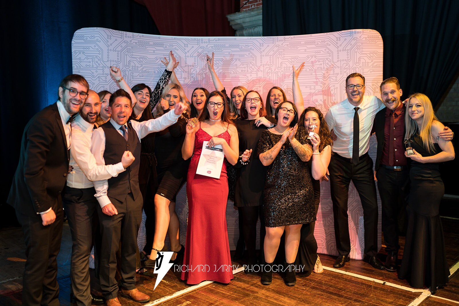 DevelopHER Awards finalists and guests celebrating in front of the awards backdrop