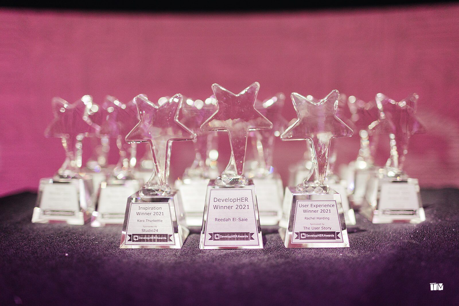Glass star trophies for the DevelopHER Awards winners lined up on a table
