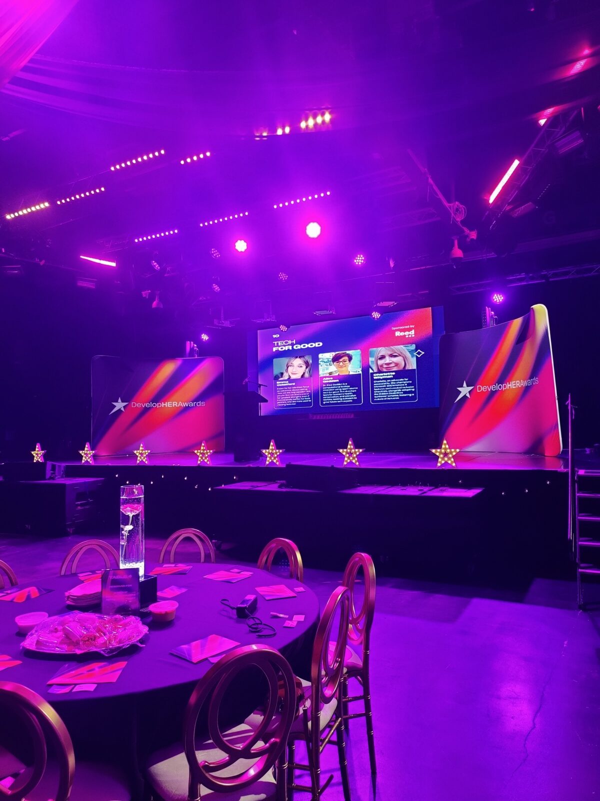 The DevelopHER Awards stage and dressed tables before the 2025 ceremony